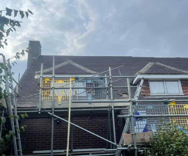 This is a photo of a roof with two dormers that is having some damaged tiles replaced. Works carried out by LKN Roofing Shortstown